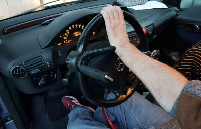 Disabled man behind a steering wheel of a car