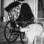 a woman in wheelchair with guide dog