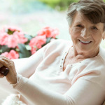 Woman with walking stick smiling