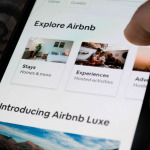 A user using the Airbnb app on a smartphone - exploring travel destinations
