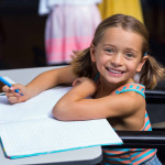 Little girl in wheelchair in classroom