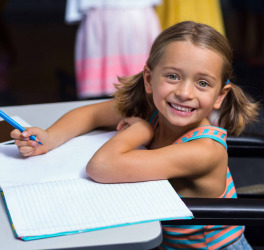 Little girl in wheelchair in classroom