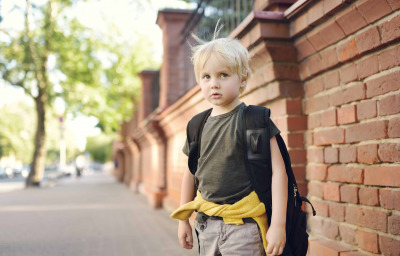 stressed little boy with backpack
