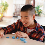 child in wheelchair molding clay, Fun and entertaining activity for training small and large muscles