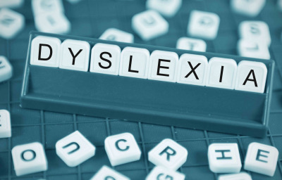 Dyslexia concept with game board and random letters