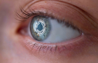 Woman's eye with lens with digital and biometric implants