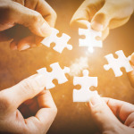 Hand of diverse people connecting jigsaw puzzle