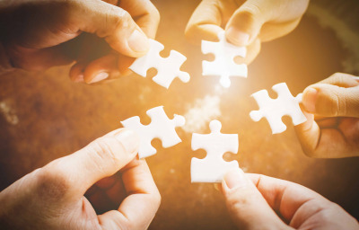 Hand of diverse people connecting jigsaw puzzle