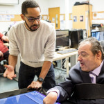 Martez Mott, left, a PhD candidate in the University of Washington’s Information School, works on Smart Touch technology with Ken Frye at Provail