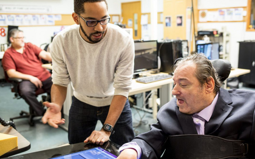 Martez Mott, left, a PhD candidate in the University of Washington’s Information School, works on Smart Touch technology with Ken Frye at Provail