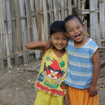 two children plays together One of them has the down syndrome