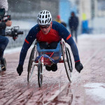Male athlete with disability participating in wheelchair racing competition