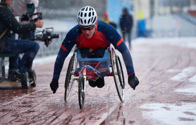 Male athlete with disability participating in wheelchair racing competition