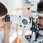 Woman doing eye test with optometrist in eye sight clinic