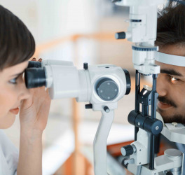 Woman doing eye test with optometrist in eye sight clinic