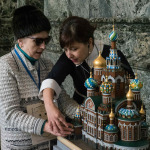 a blind woman in the state museum. The guide shows the blind woman exhibits.