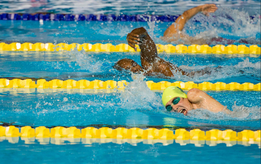 participants gushing through water in swimming competition