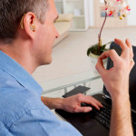 Deaf man talking using sign language on the laptop