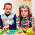 cheerful kids playing together in daycare center for kids with disabilities