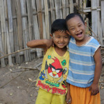 two children plays together One of them has the down syndrome