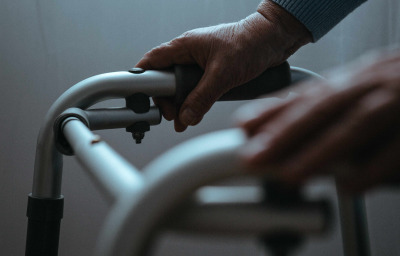 Person holding hands on walker