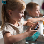 kid playing game with smartphone