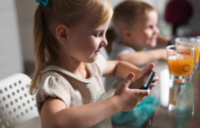 kid playing game with smartphone