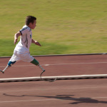 young disabled athlete running 100m sprint