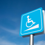 Disabled parking signage with blue sky