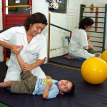 Female Therapist works with a child with disability