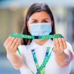 airport staff holding sunflower lanyard