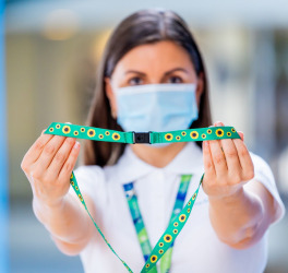 airport staff holding sunflower lanyard