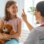 Doctor examining a child in a hospital