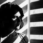 face of a girl, standing near window