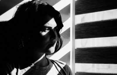 face of a girl, standing near window