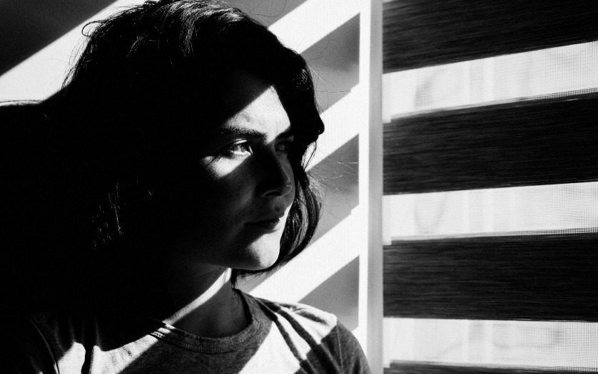 face of a girl, standing near window