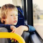 autistic boy sitting in empty bus