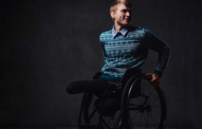 portrait of a man in wheelchair over grey background
