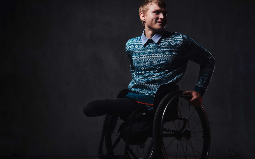 portrait of a man in wheelchair over grey background