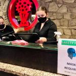 Safety signs that say masks required at the reception of the building