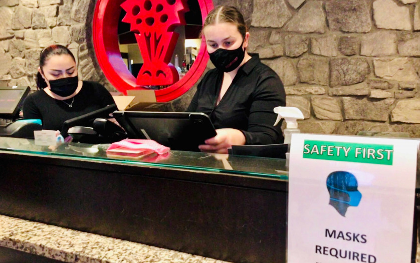Safety signs that say masks required at the reception of the building