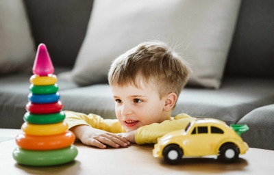 Young school kid with autism playing with kids on a therapy
