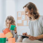 school psychologist analyzing boy's behavior during session