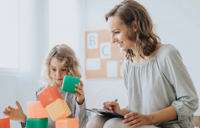 school psychologist analyzing boy's behavior during session
