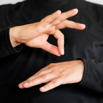 Close-up interpreter teaching sign language