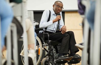 speaker in wheelchair speaking at conference