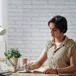 Indian lady taking notes in planner