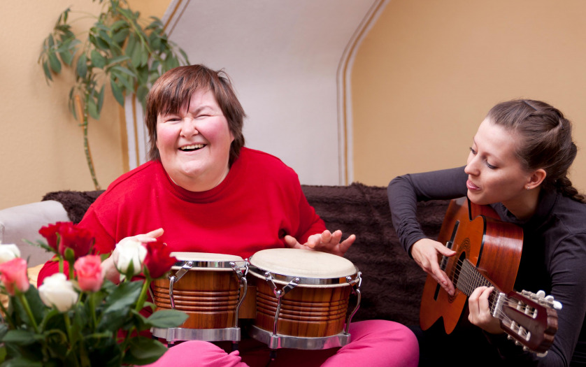 Two women make a music therapy and having fun at center