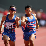 Thailand's blind athlete Kitsana Jorchuy runs with a guide at the track and field event of the fifth ASEAN Para Games on August 15, 2009 in Kuala Lumpur.
