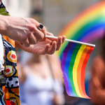 hand hold LGBT paper flag